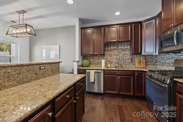 a kitchen with kitchen island granite countertop wooden cabinets and a stove