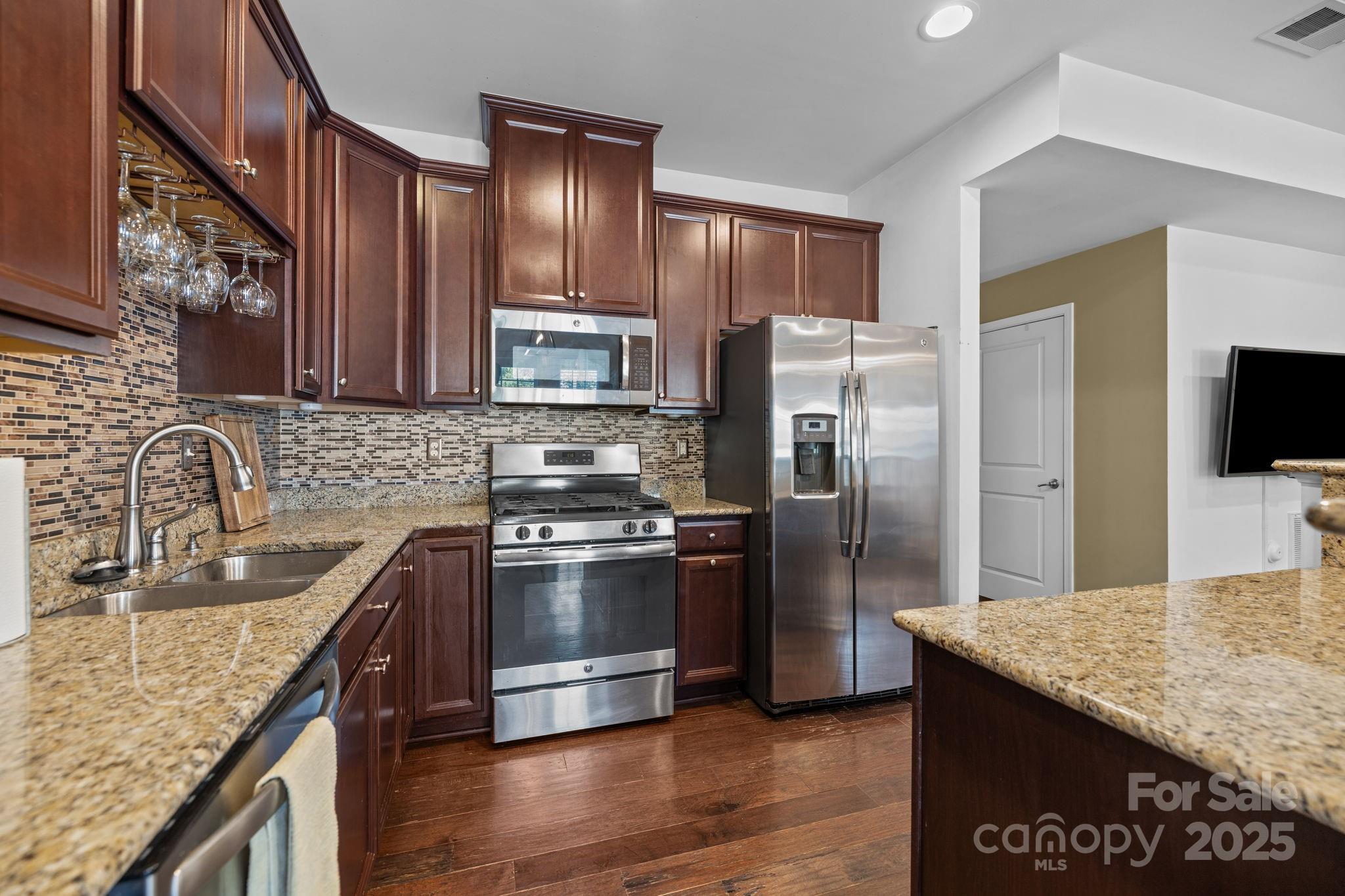 7443 Red Mulberry Way Charlotte, NC 28273 - Photo 28 of 45 a kitchen with stainless steel appliances granite countertop a sink stove and refrigerator