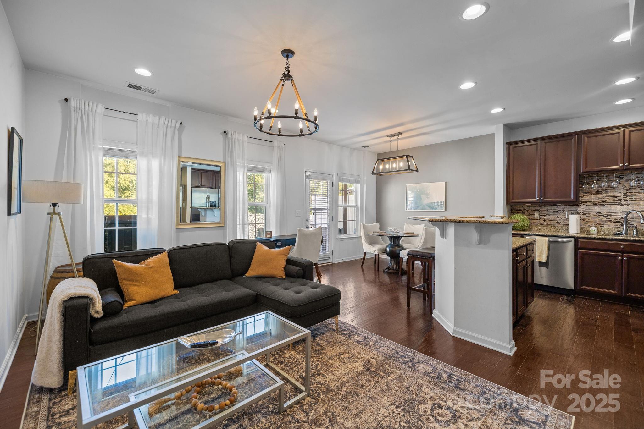 7443 Red Mulberry Way Charlotte, NC 28273 - Photo 32 of 45 a living room with furniture wooden floor and kitchen view
