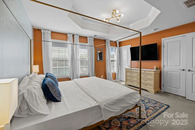 a bedroom with a bed and a television