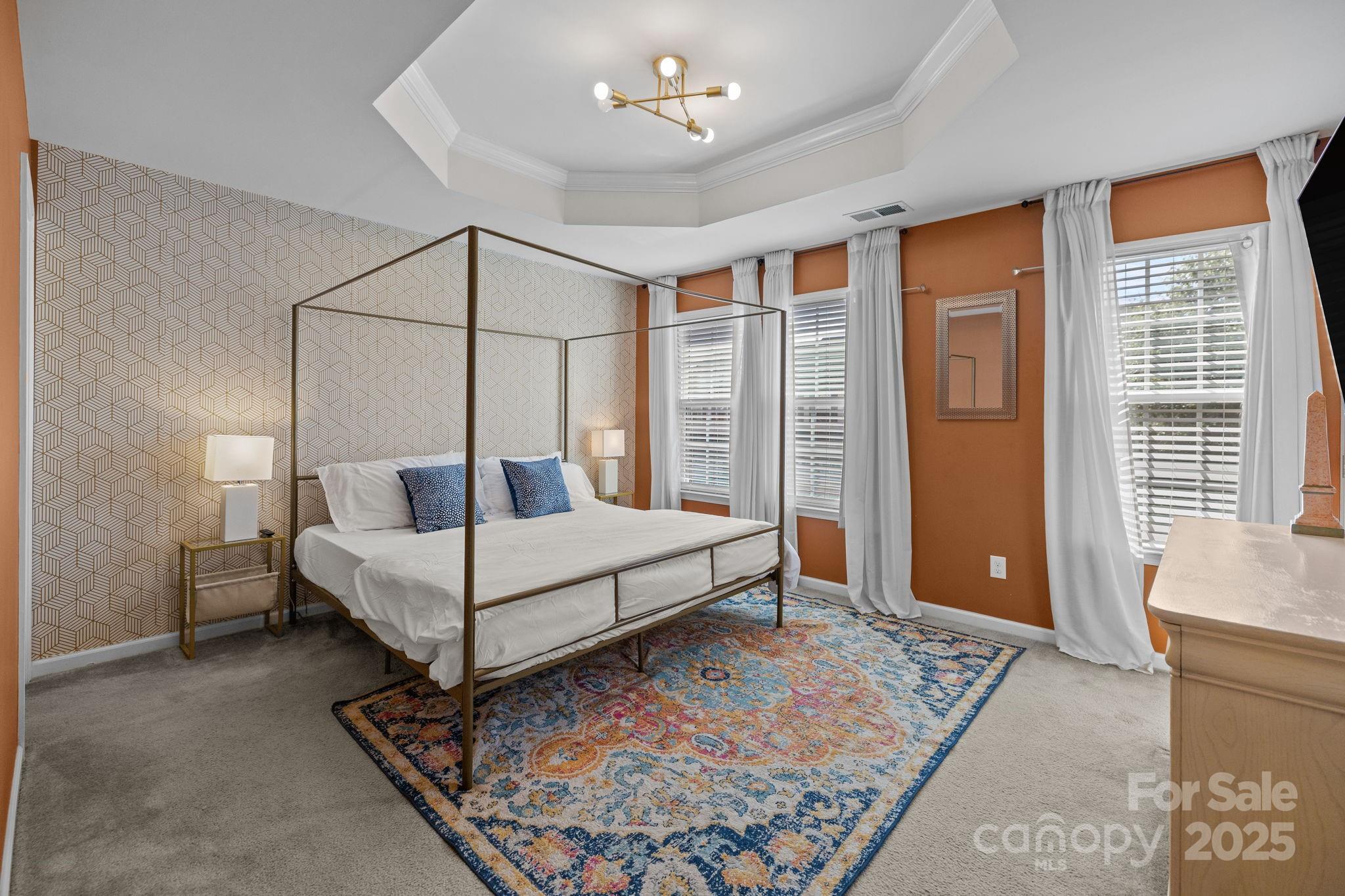 7443 Red Mulberry Way Charlotte, NC 28273 - Photo 36 of 45 a bedroom with a bed and a chandelier