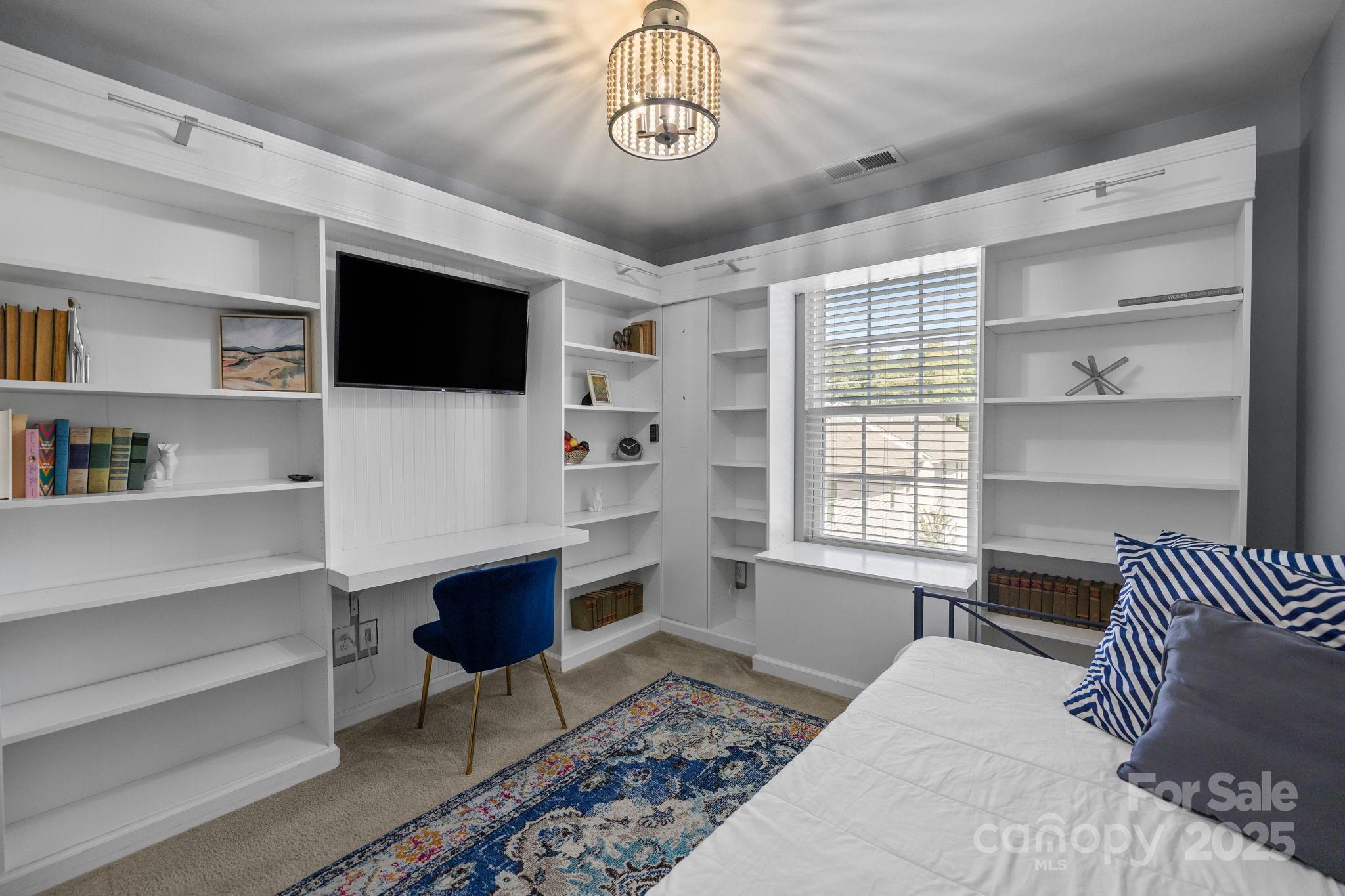 7443 Red Mulberry Way Charlotte, NC 28273 - Photo 38 of 45 a bedroom with a bed a flat screen tv and a window