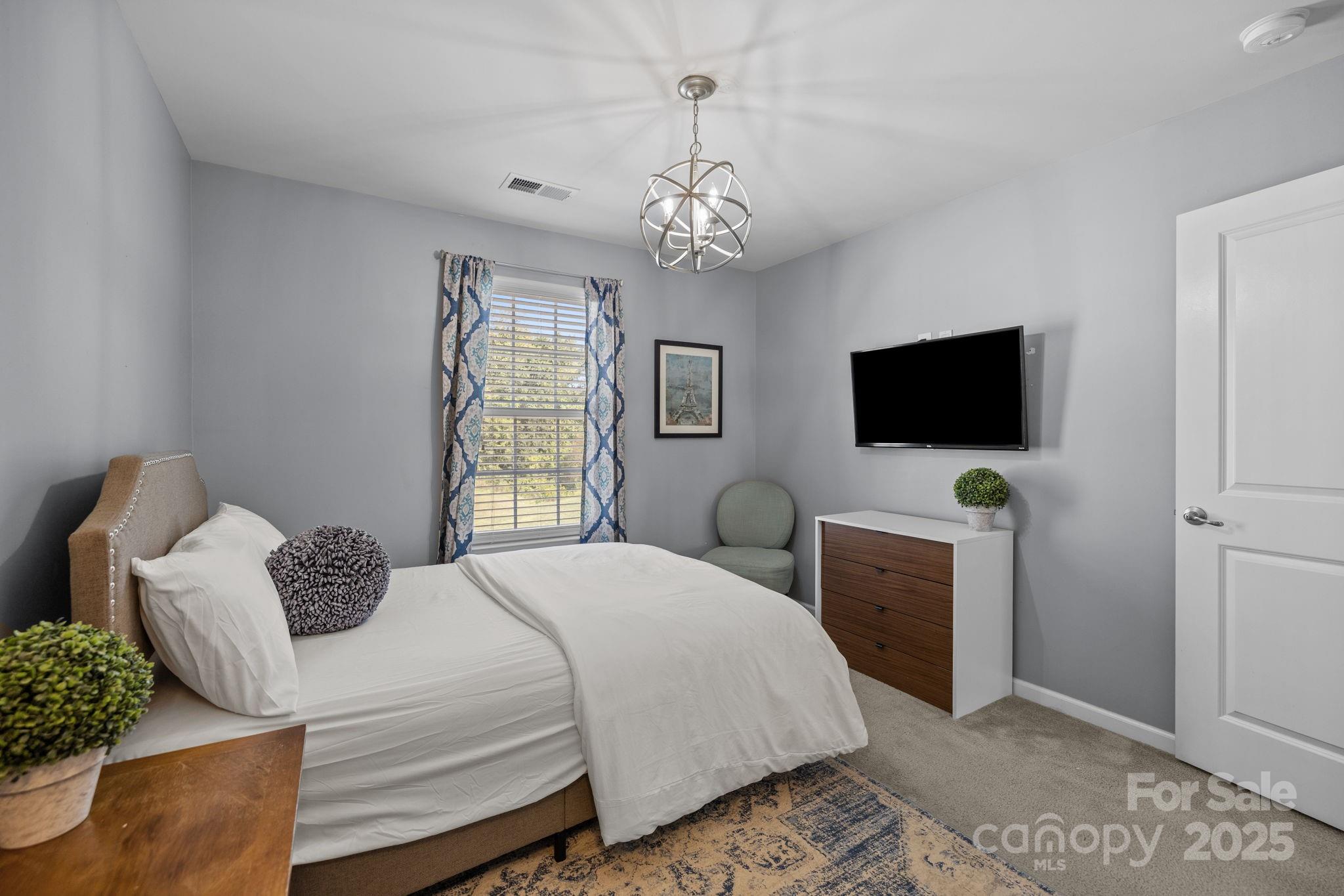 7443 Red Mulberry Way Charlotte, NC 28273 - Photo 41 of 45 a bedroom with bed tv and window