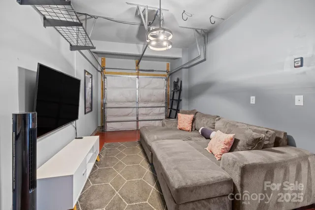 a living room with couches and a flat screen tv