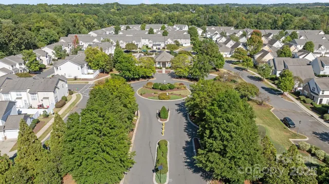 an aerial view of a house with a yard and lake view