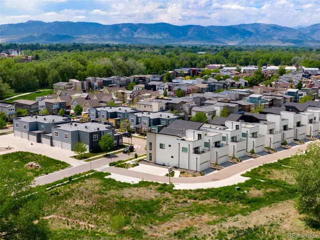 an aerial view of residential houses with outdoor space