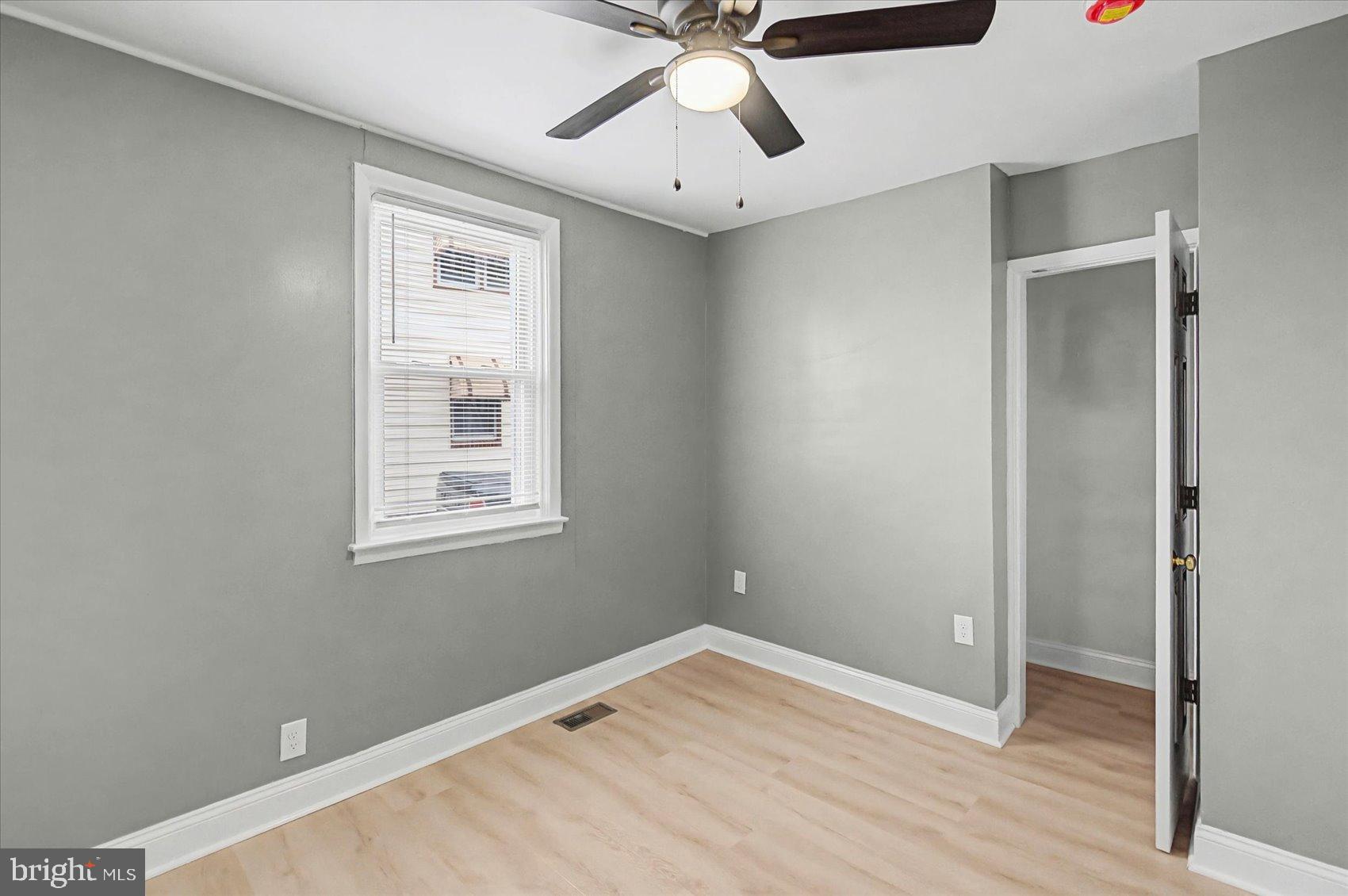200 Pinewood Road Dundalk, MD 21222 - Photo 13 of 39 an empty room with wooden floor fan and windows