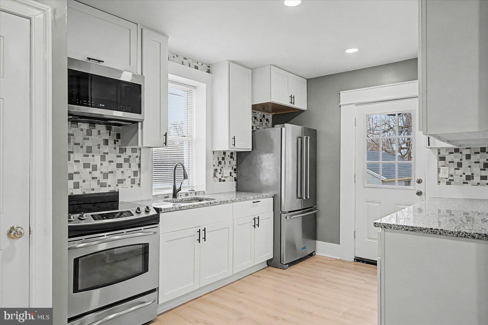 200 Pinewood Road Dundalk, MD 21222 - Photo 2 of 39 a kitchen with stainless steel appliances a refrigerator stove and microwave