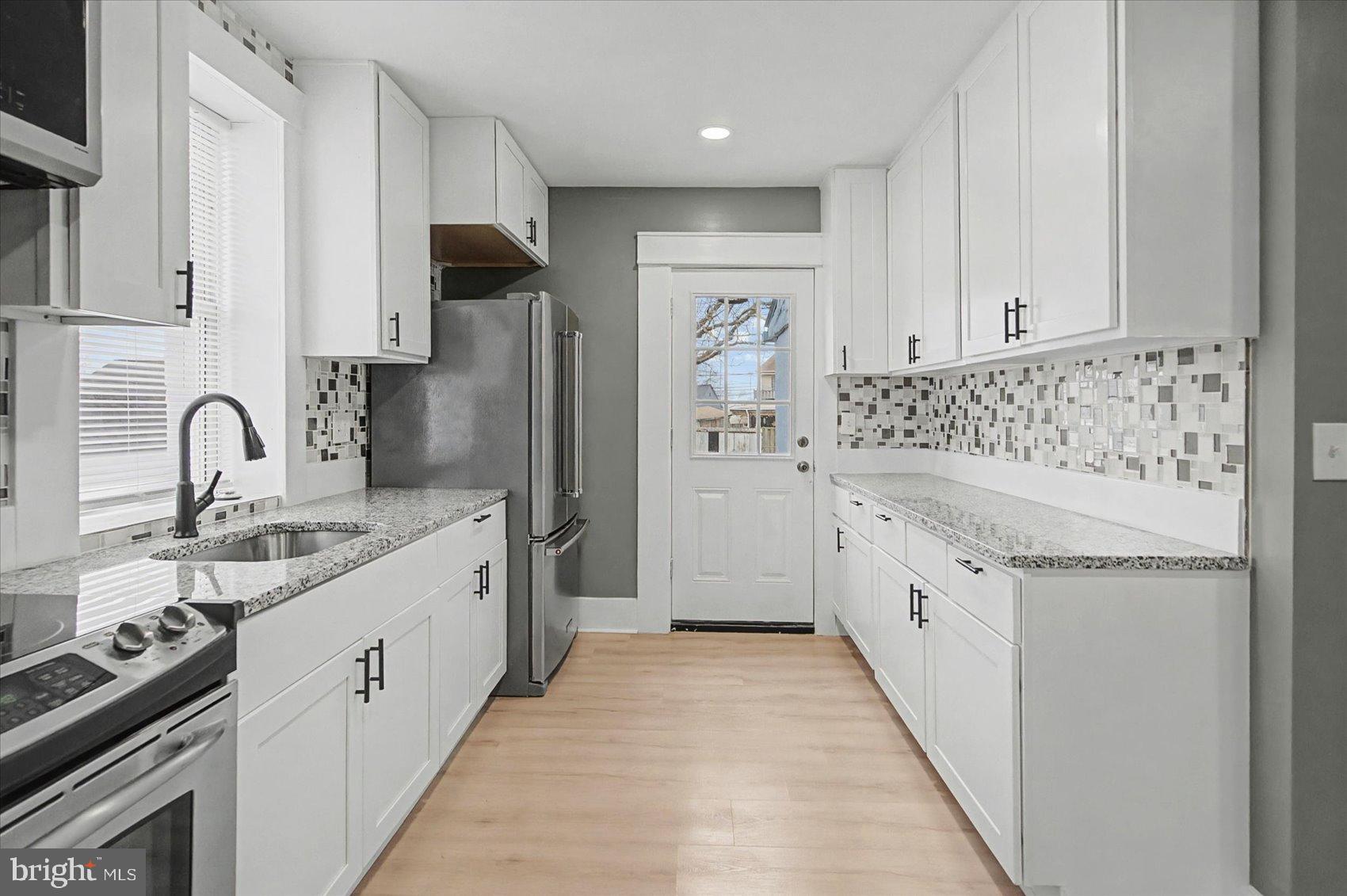 200 Pinewood Road Dundalk, MD 21222 - Photo 3 of 39 a kitchen with granite countertop a sink stove and refrigerator