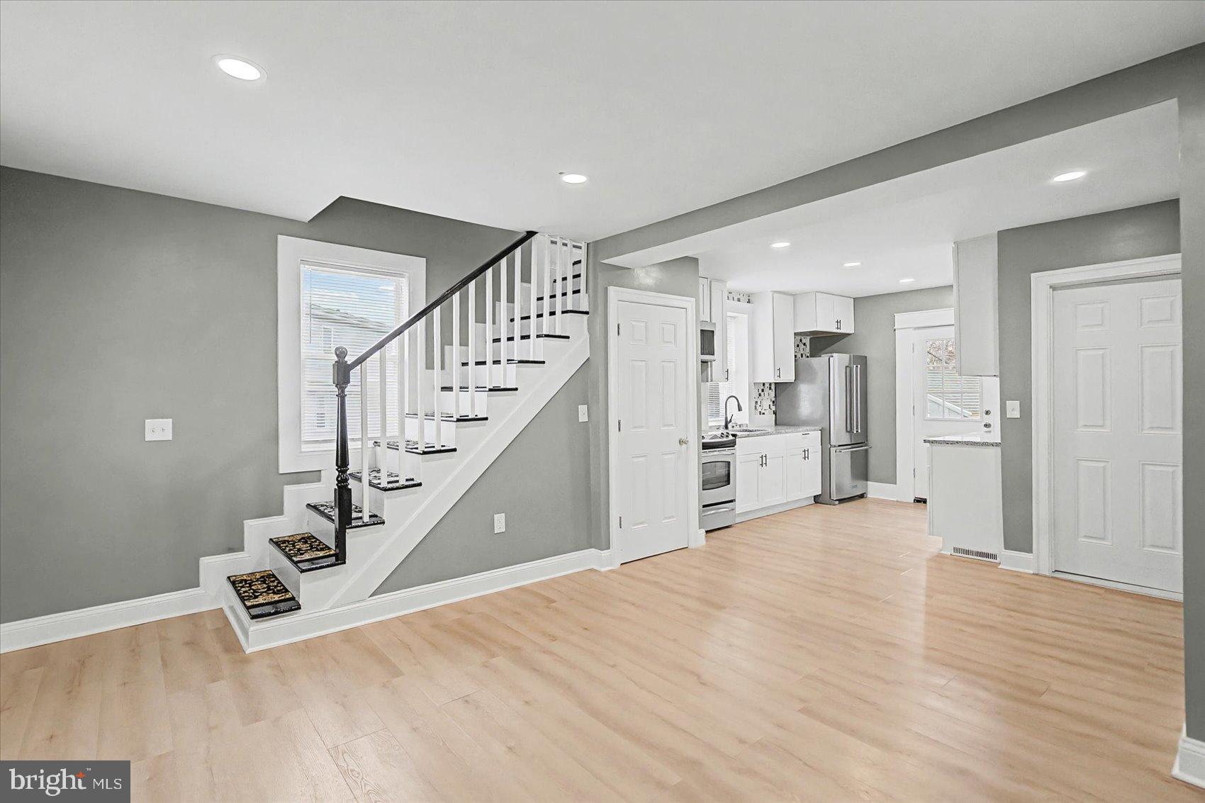 200 Pinewood Road Dundalk, MD 21222 - Photo 6 of 39 a view of a hallway with wooden floor and staircase
