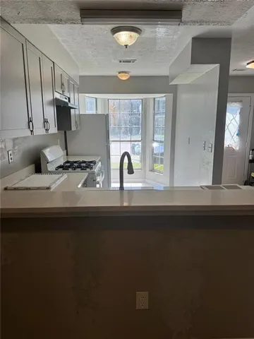 a kitchen with a refrigerator and a sink