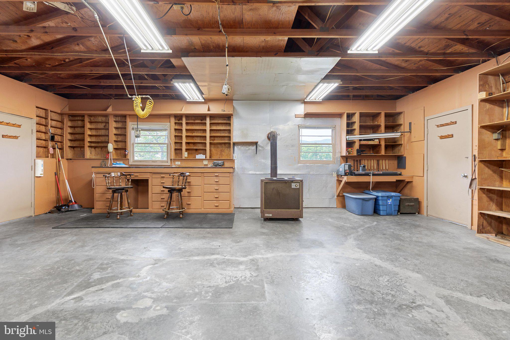 101 Nelson Road Strasburg, VA 22657 - Photo 40 of 68 Work area in garage with woodstove
