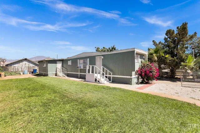 a view of a house with backyard porch and sitting area