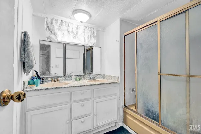 a bathroom with a double vanity sink and a mirror