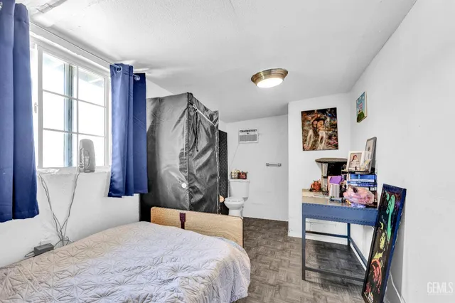 a bedroom with a bed and a window