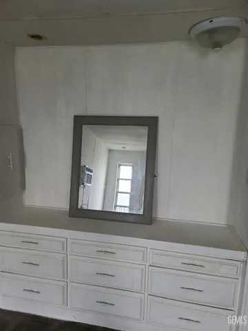 a bathroom with a sink mirror and vanity