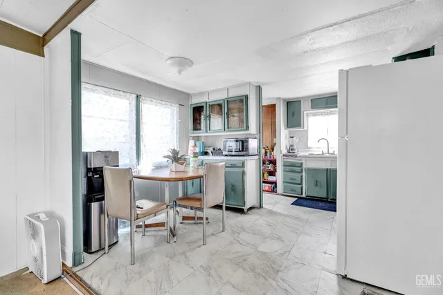 a dining room with furniture a window and kitchen view