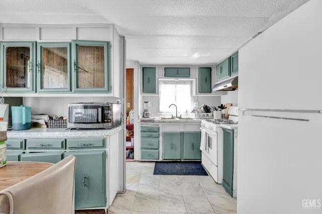 a kitchen with a sink cabinets and window