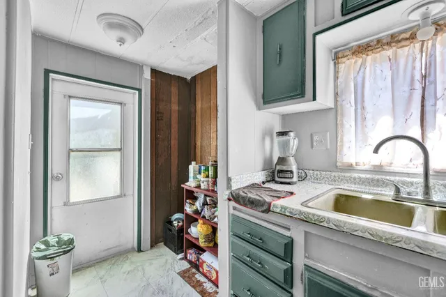a kitchen with a sink cabinets and window