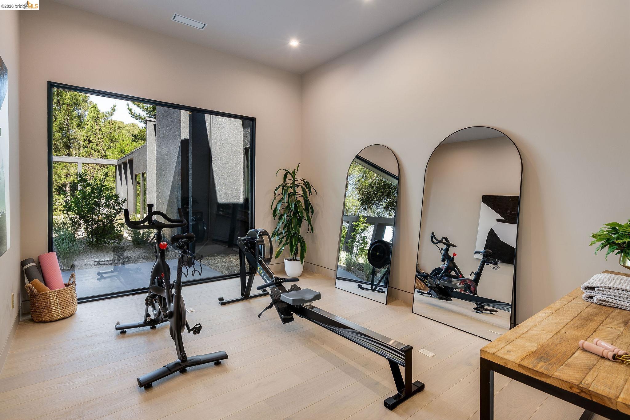 5645 Bacon Road Oakland, CA 94619 - Photo 54 of 94 Dedicated fitness space featuring a full-height black-framed window, light wood-finish flooring, recessed lighting, and neutral wall tones