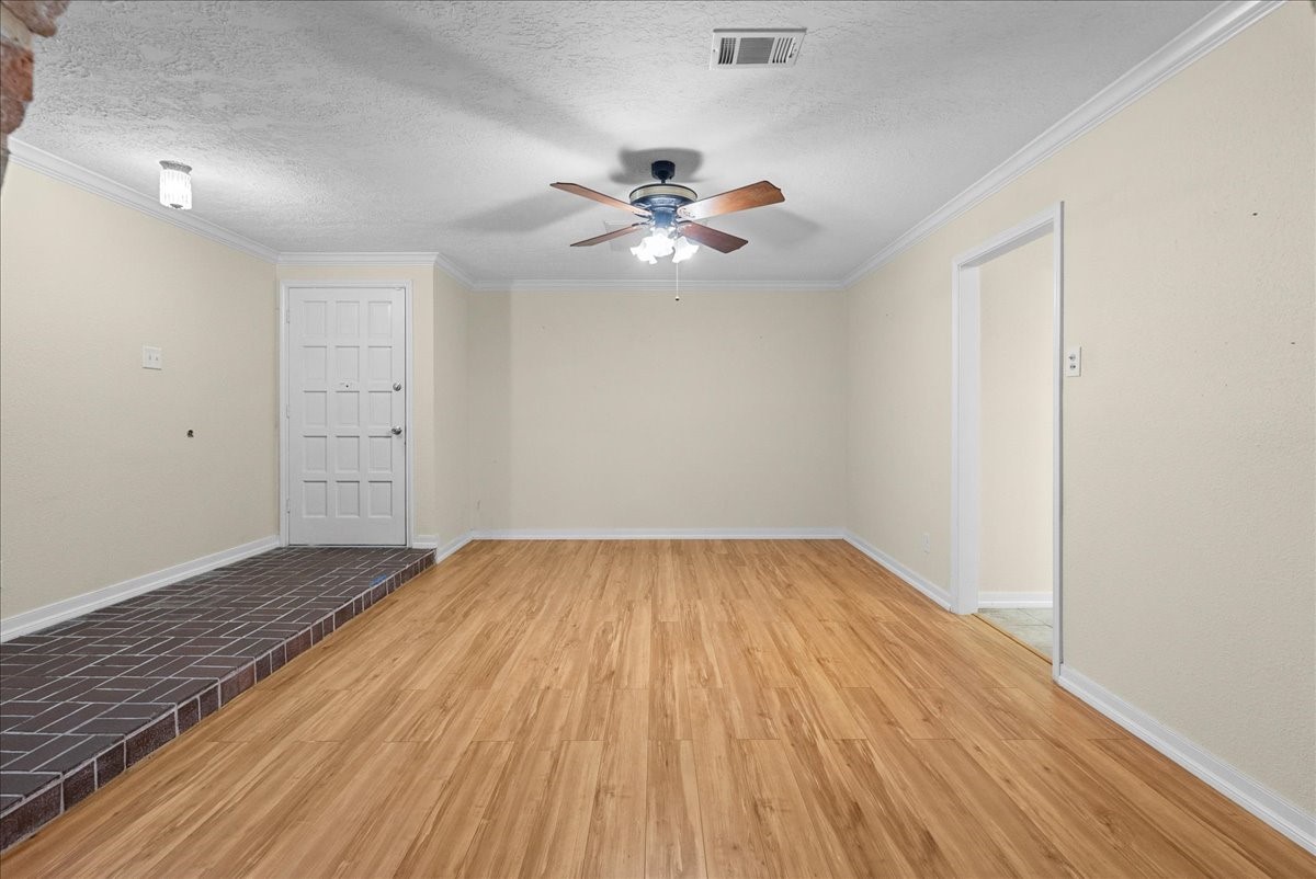 3727 Rau Drive Dickinson, TX 77539 - Photo 16 of 45 an empty room with wooden floor fan and windows