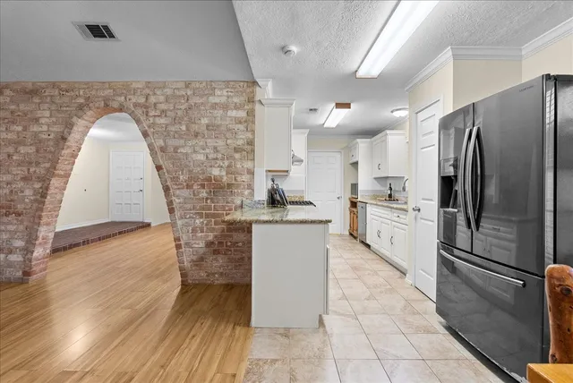 a kitchen with stainless steel appliances a stove a sink and a microwave