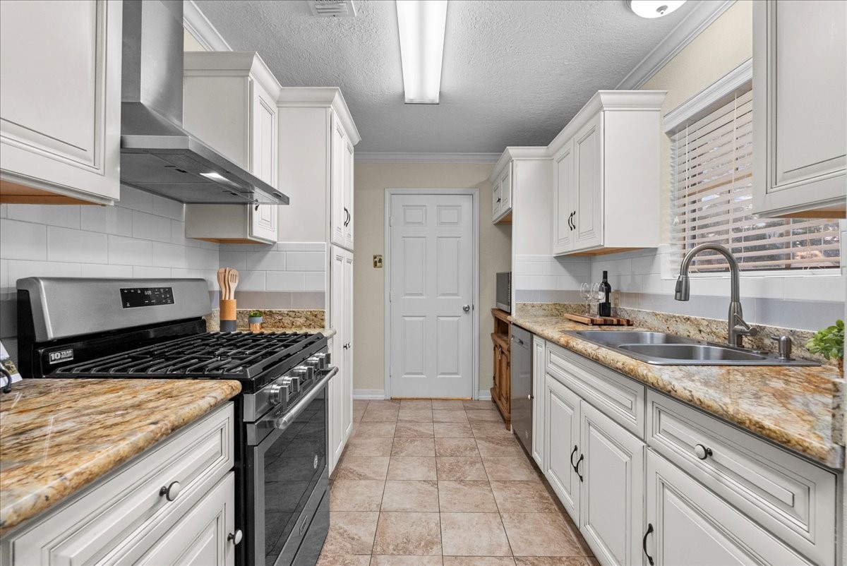 3727 Rau Drive Dickinson, TX 77539 - Photo 23 of 45 a kitchen with stainless steel appliances granite countertop a stove and a sink