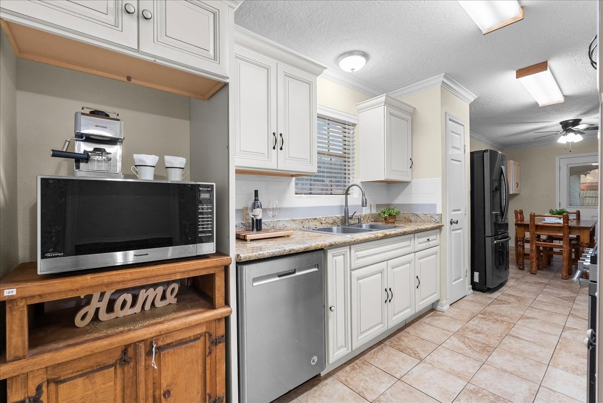 3727 Rau Drive Dickinson, TX 77539 - Photo 24 of 45 a kitchen with stainless steel appliances a stove a sink and a microwave
