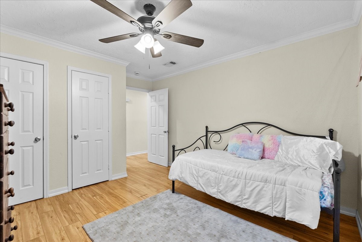 3727 Rau Drive Dickinson, TX 77539 - Photo 28 of 45 a bedroom with a large bed and a chandelier