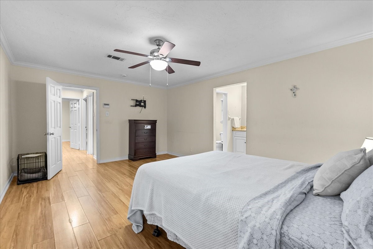 3727 Rau Drive Dickinson, TX 77539 - Photo 31 of 45 a bedroom with a bed and wooden floor