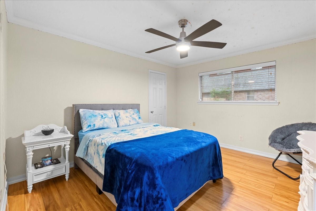 3727 Rau Drive Dickinson, TX 77539 - Photo 34 of 45 a bedroom with a bed and a chandelier