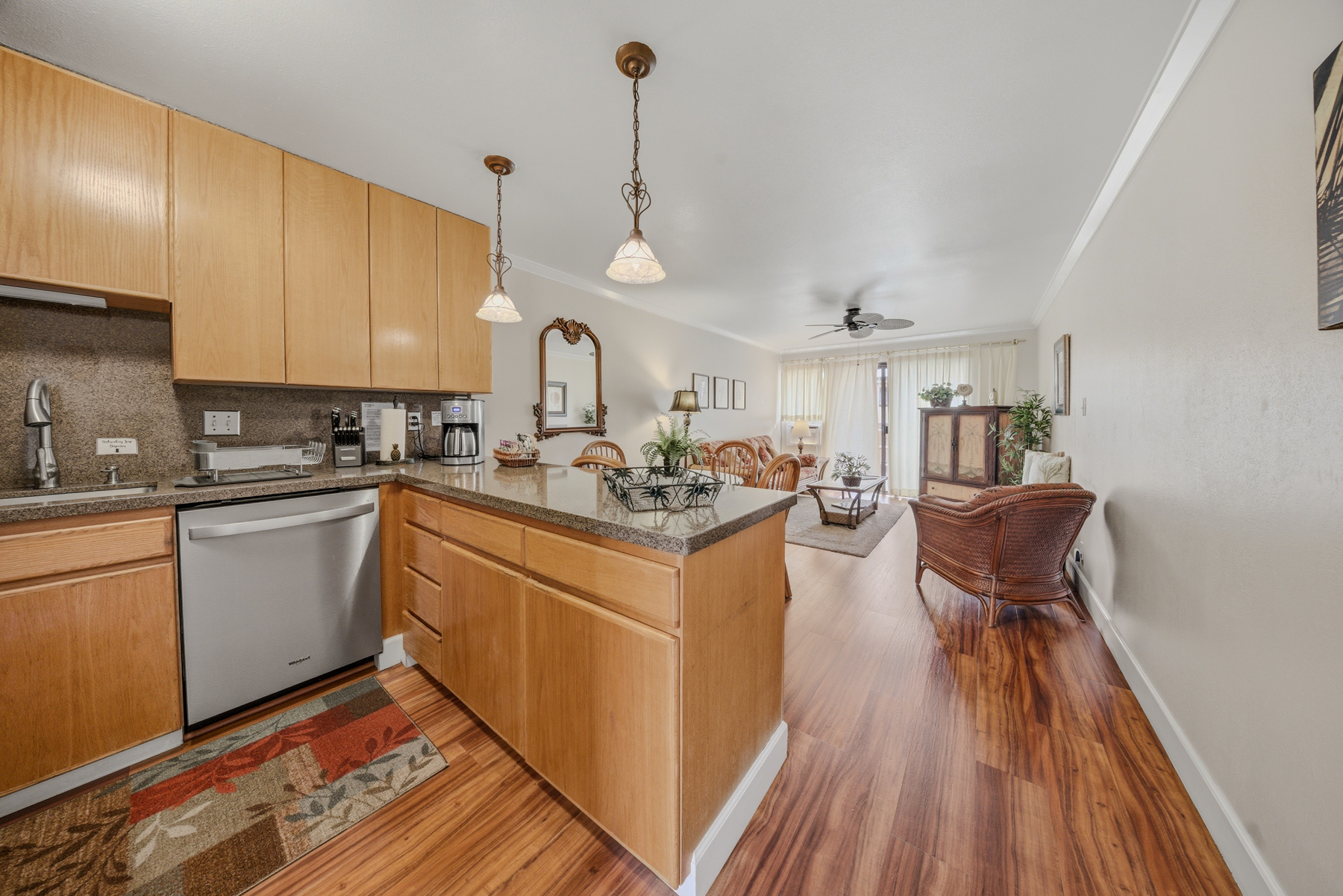 3411 Wilcox Road, Unit AIII9 Lihue, HI 96766 - Photo 5 of 13 a kitchen with stainless steel appliances granite countertop a sink dishwasher a stove and white cabinets with wooden floor