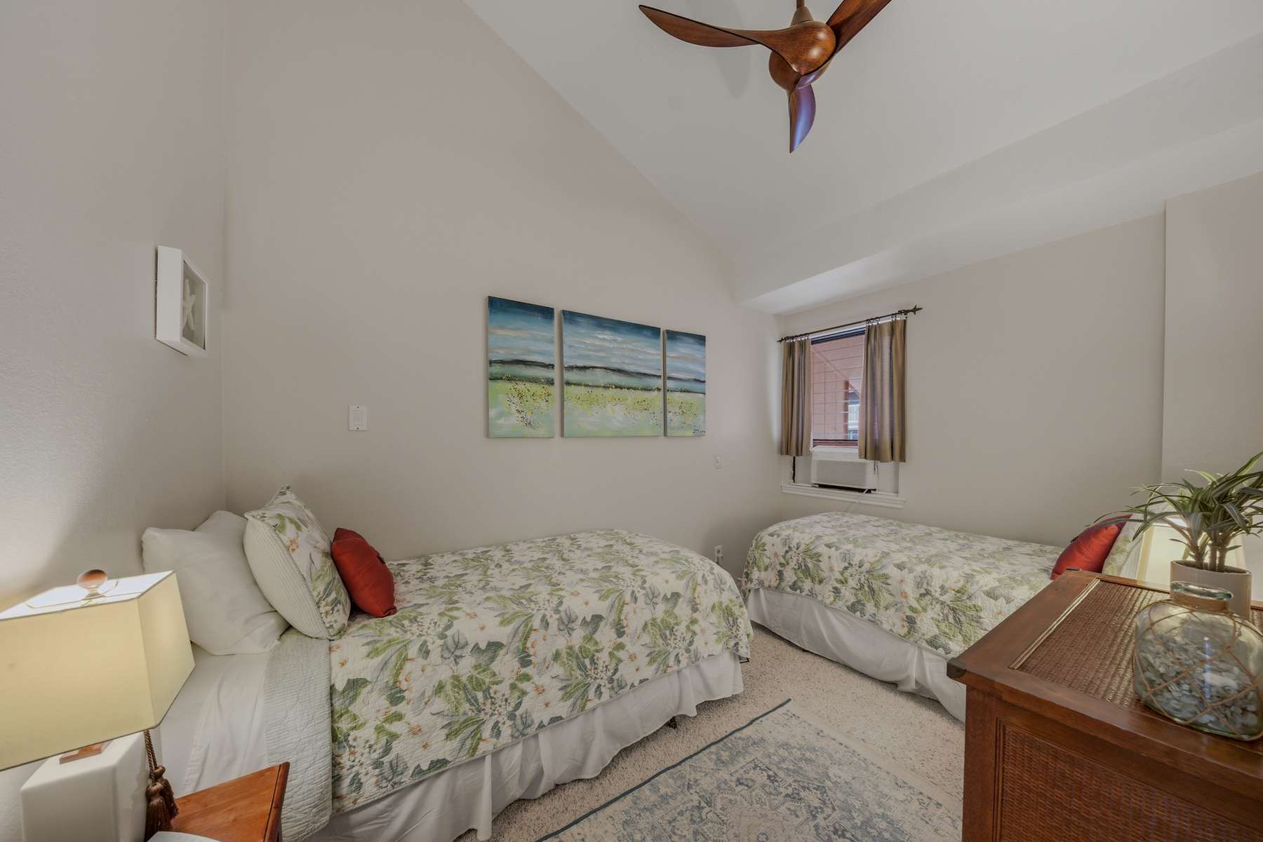 3411 Wilcox Road, Unit AIII9 Lihue, HI 96766 - Photo 9 of 13 a bedroom with two beds and a dresser