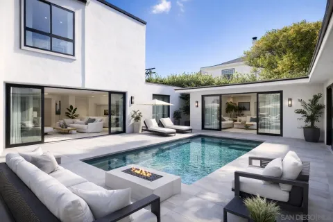 a view of a backyard with swimming pool and furniture
