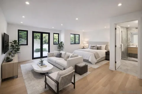 a bedroom with furniture and a large window