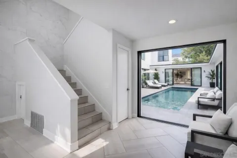 a view of a livingroom with furniture wooden floor and windows