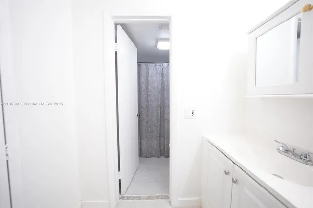 a white toilet sitting next to a bath tub