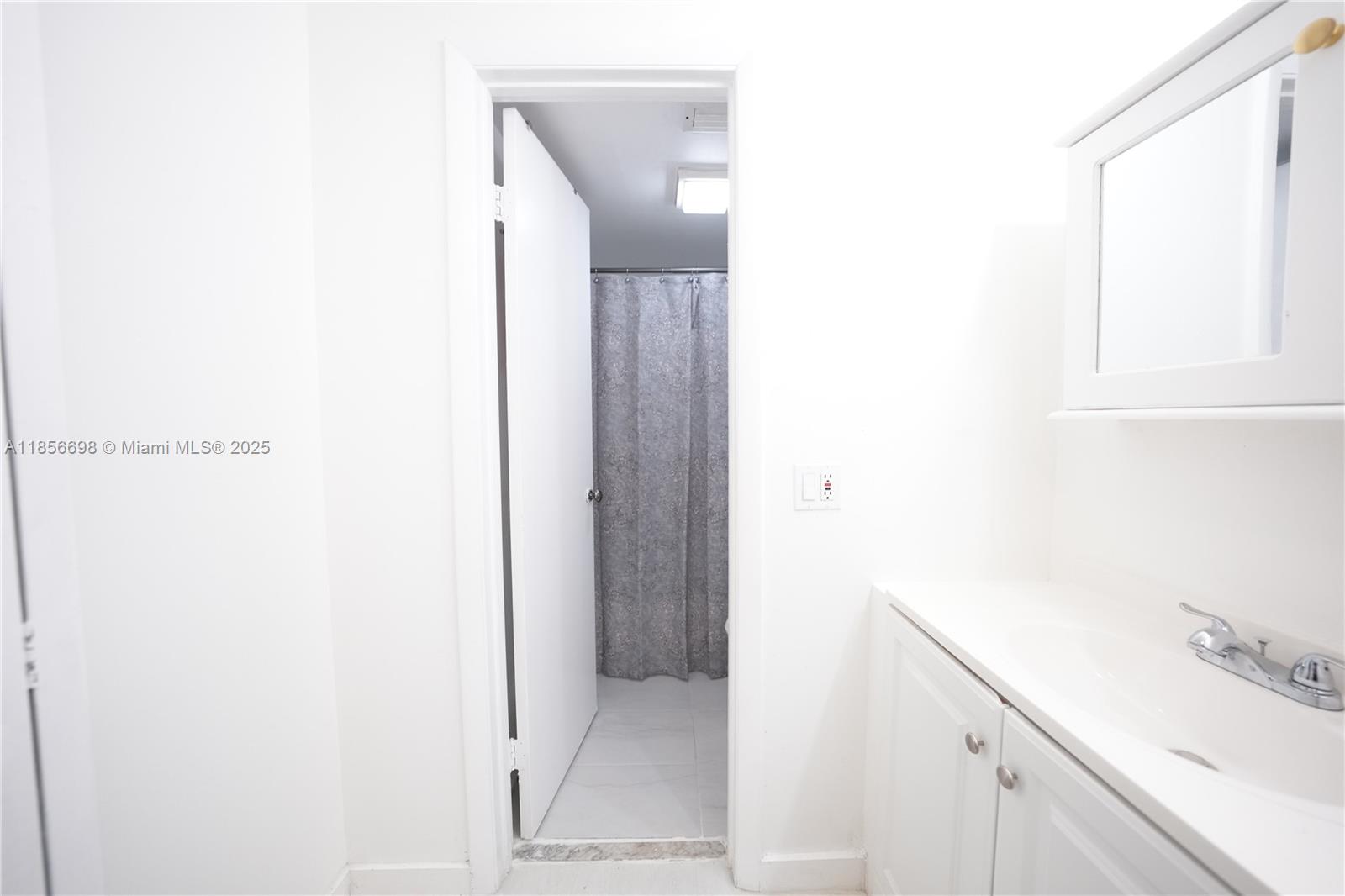 21121 Southwest 85th Avenue, Unit 117 Cutler Bay, FL 33189 - Photo 11 of 15 a bathroom with a sink and a mirror