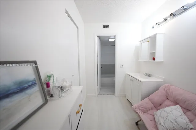 a view of open kitchen with a sink and a large mirror