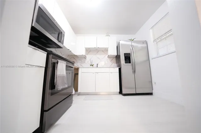 a kitchen with a sink stove and microwave