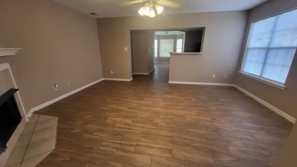 a view of room with window and wooden floor