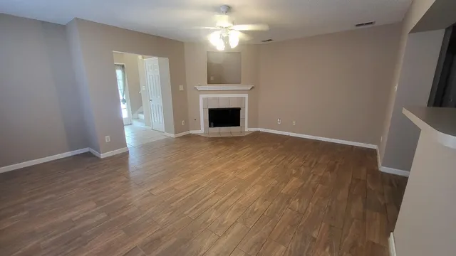 wooden floor in an empty room with a fireplace