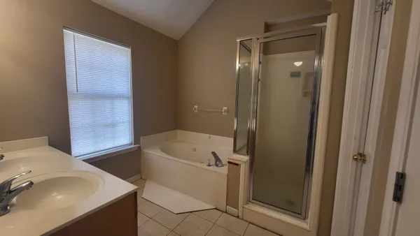 a bathroom with a tub sink and toilet
