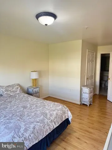 a bedroom with a bed and a view of kitchen