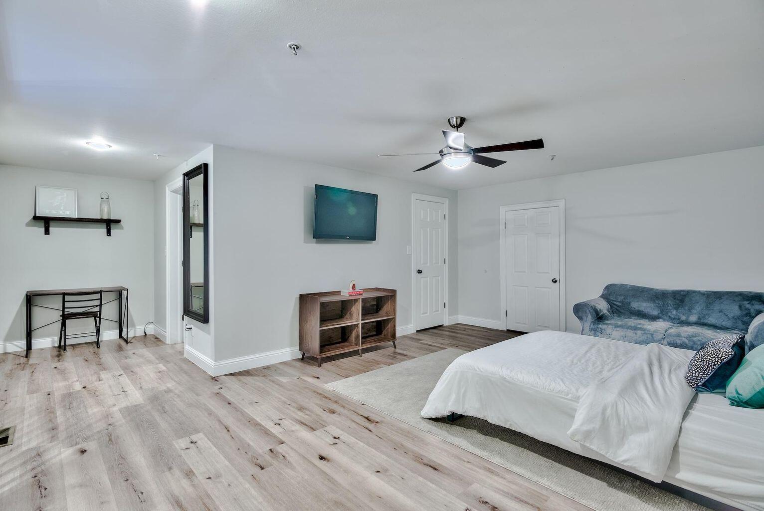 4507 Furling Lane, Unit 302 Destin, FL 32541 - Photo 11 of 15 a bedroom with a bed and a flat screen tv