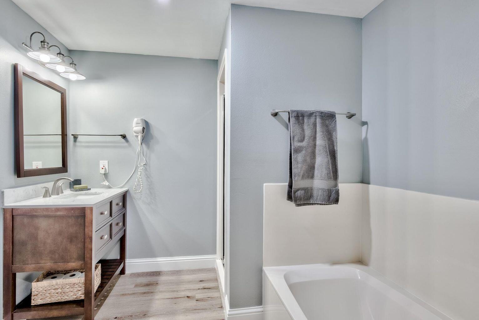 4507 Furling Lane, Unit 302 Destin, FL 32541 - Photo 13 of 15 a bathroom with a sink and a mirror