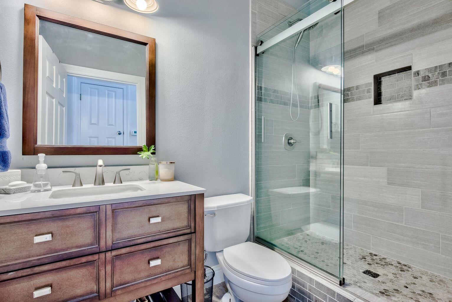 4507 Furling Lane, Unit 302 Destin, FL 32541 - Photo 4 of 15 a bathroom with a sink a toilet and shower