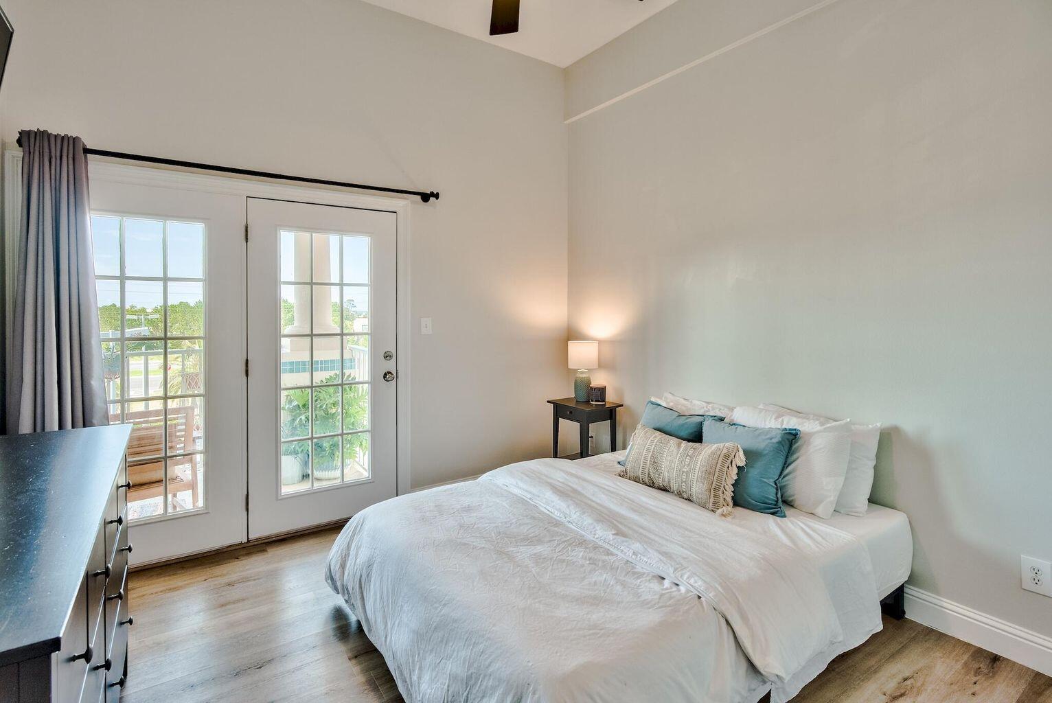 4507 Furling Lane, Unit 302 Destin, FL 32541 - Photo 5 of 15 a bedroom with a large bed and a large window