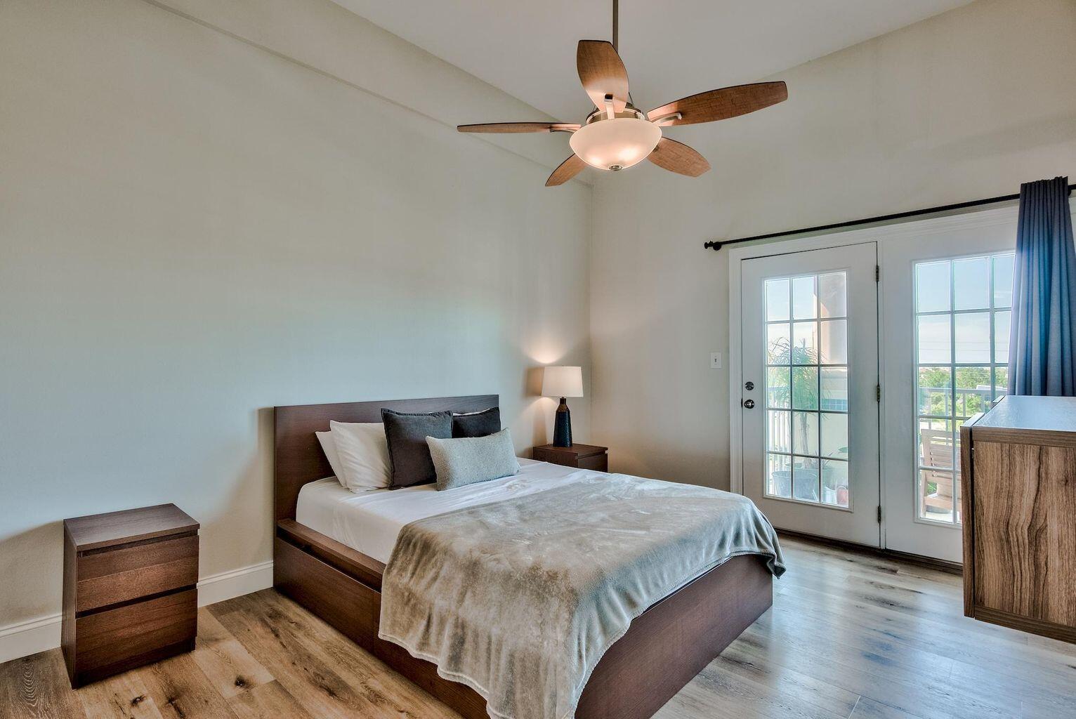 4507 Furling Lane, Unit 302 Destin, FL 32541 - Photo 7 of 15 a bedroom with a large bed and a window