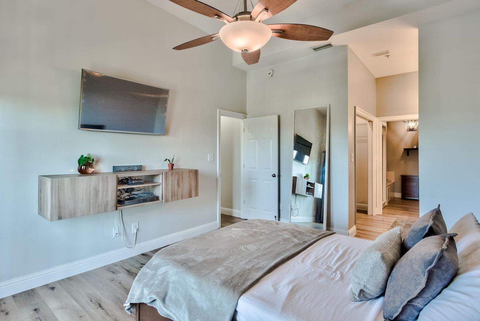 4507 Furling Lane, Unit 302 Destin, FL 32541 - Photo 8 of 15 a bedroom with furniture and a flat screen tv